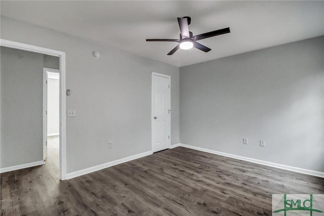 empty room featuring dark wood-type flooring and ceiling fan