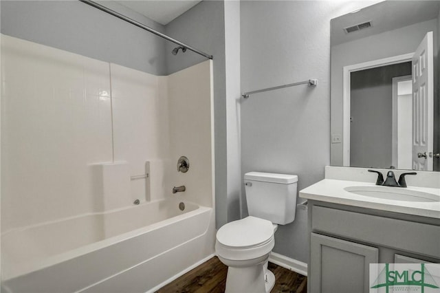 full bathroom with vanity, hardwood / wood-style flooring, bathing tub / shower combination, and toilet