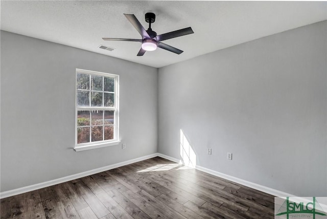 empty room featuring dark hardwood / wood-style flooring and ceiling fan