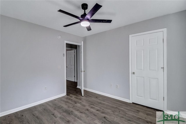 unfurnished bedroom featuring dark wood-type flooring and ceiling fan