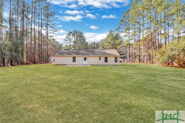 back of house with a yard