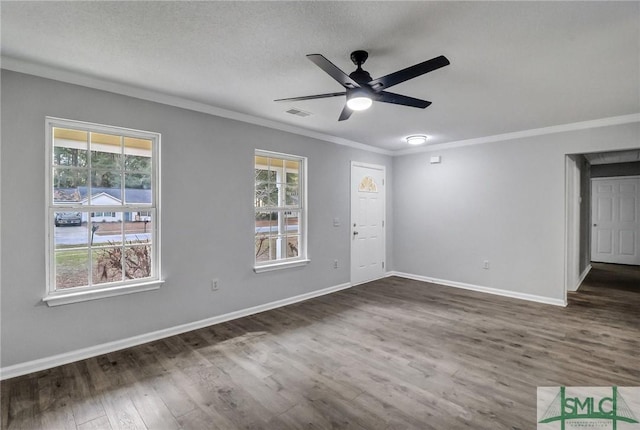 interior space with dark wood-type flooring, ceiling fan, crown molding, and a wealth of natural light