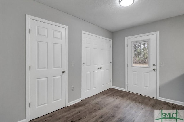 entryway with hardwood / wood-style flooring and a textured ceiling