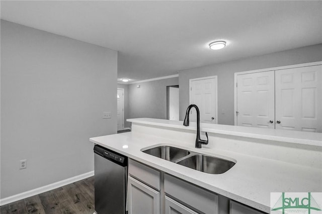 kitchen featuring dishwasher, sink, and dark hardwood / wood-style floors