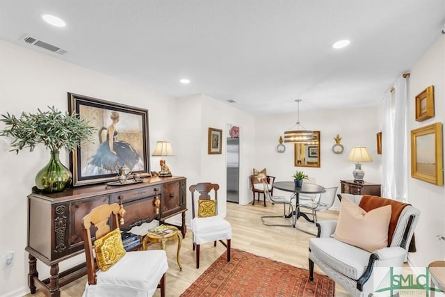 sitting room featuring light hardwood / wood-style flooring