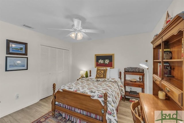 bedroom with ceiling fan, a closet, and light wood-type flooring