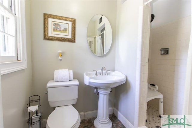 bathroom featuring a shower with curtain and toilet