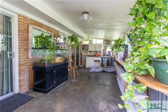 view of patio featuring an AC wall unit, area for grilling, and ceiling fan