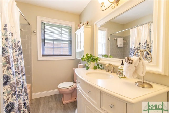 full bathroom featuring vanity, hardwood / wood-style floors, toilet, and shower / tub combo with curtain