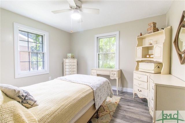 bedroom with dark hardwood / wood-style flooring and ceiling fan