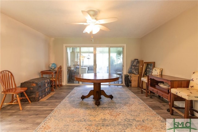 dining space with hardwood / wood-style floors and ceiling fan