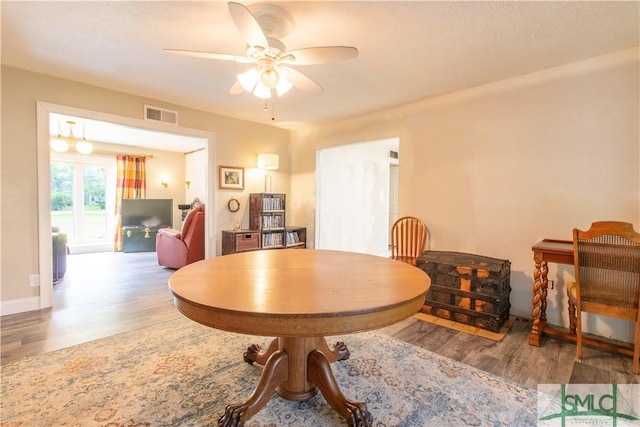 dining space featuring hardwood / wood-style floors and ceiling fan