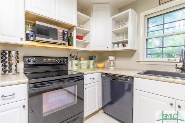 kitchen featuring white cabinetry, sink, and black appliances