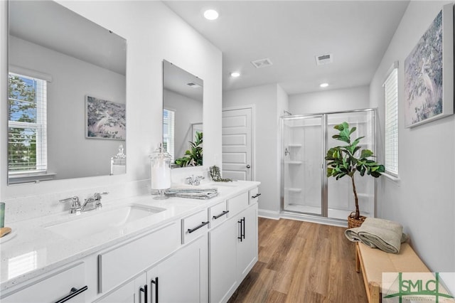 bathroom featuring vanity, hardwood / wood-style floors, and an enclosed shower