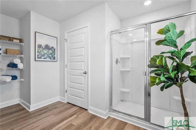 bathroom featuring wood-type flooring and walk in shower