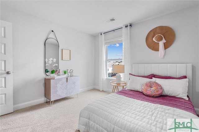 bedroom featuring light colored carpet