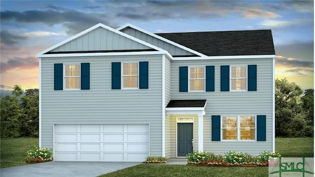 view of front of house with a yard and a garage