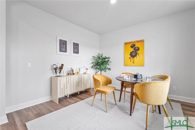 dining space with hardwood / wood-style flooring