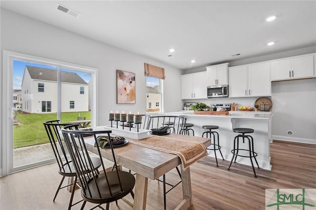 dining area featuring light wood-type flooring