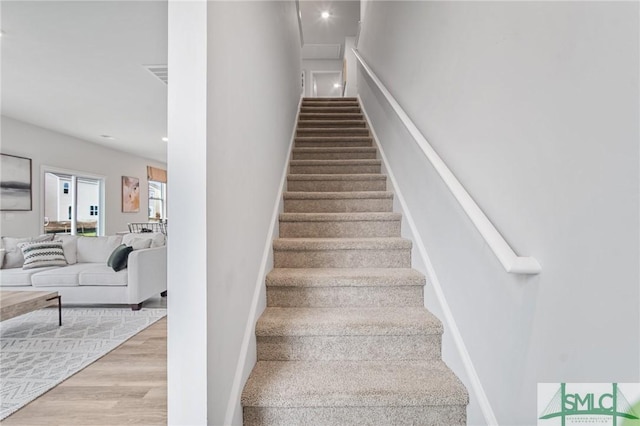 staircase featuring hardwood / wood-style flooring