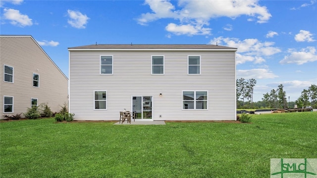 rear view of property featuring a patio area and a lawn