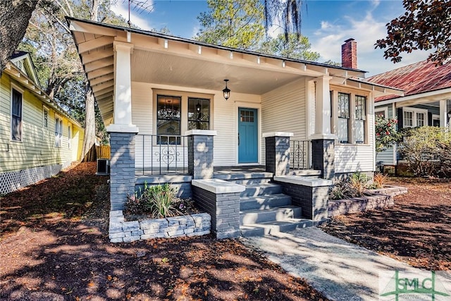 view of front of property featuring a porch and central AC