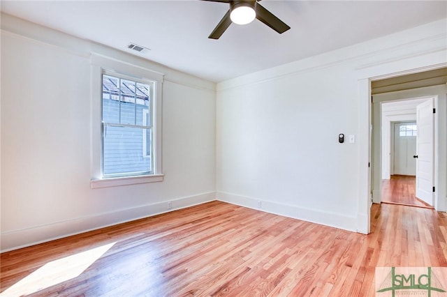 empty room with ceiling fan and light hardwood / wood-style floors