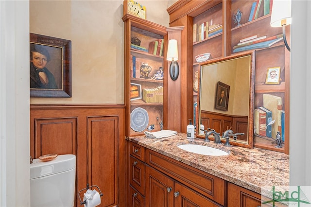 bathroom featuring vanity and toilet