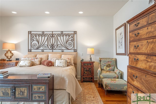 bedroom with dark hardwood / wood-style flooring