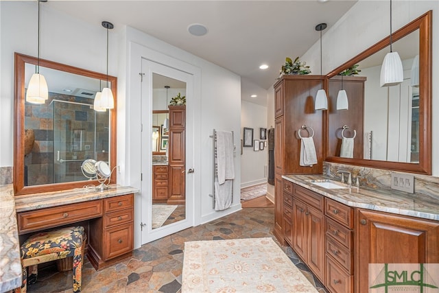 bathroom with vanity, decorative backsplash, and a shower with door