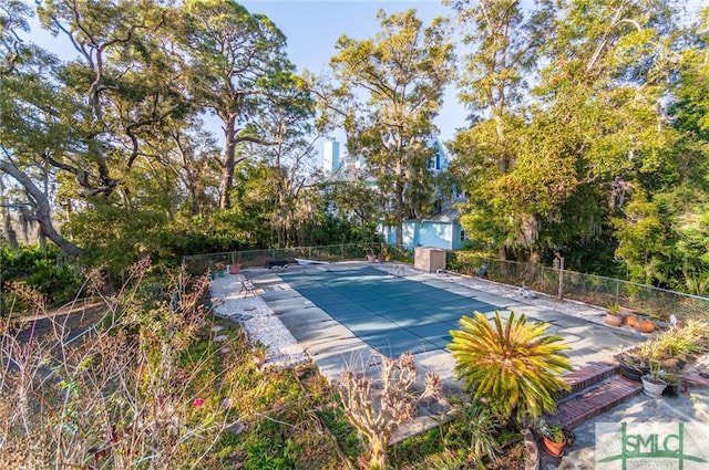 exterior space with a covered pool and a patio area