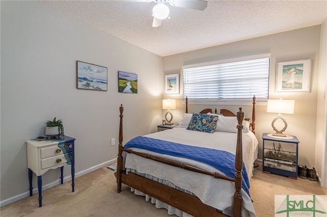 bedroom with ceiling fan, light carpet, and a textured ceiling