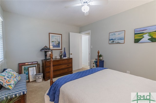 bedroom featuring light colored carpet and ceiling fan