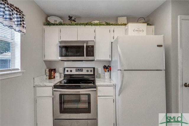 kitchen featuring appliances with stainless steel finishes and white cabinets