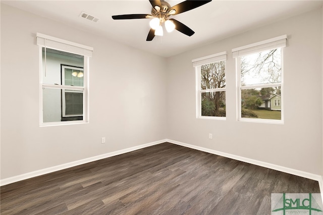 spare room with dark wood-type flooring and ceiling fan