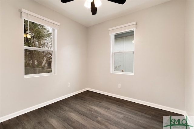 spare room featuring ceiling fan and dark hardwood / wood-style floors