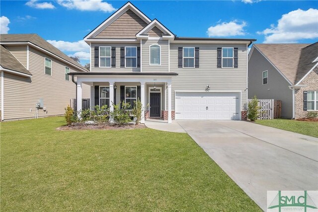 view of front of property with a garage, covered porch, and a front yard