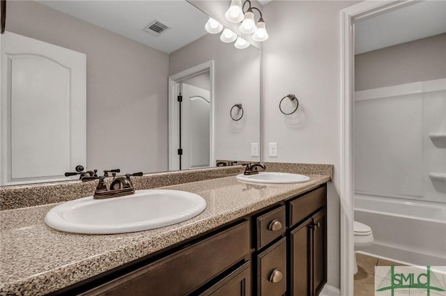 bathroom featuring vanity, tile patterned flooring, and toilet