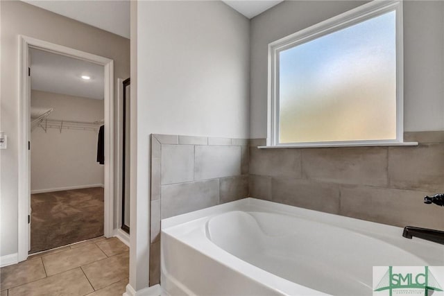 bathroom featuring tile patterned flooring and plus walk in shower