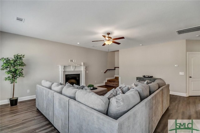 living room featuring dark hardwood / wood-style floors and ceiling fan