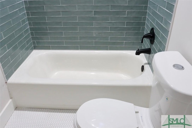 bathroom with washtub / shower combination and toilet