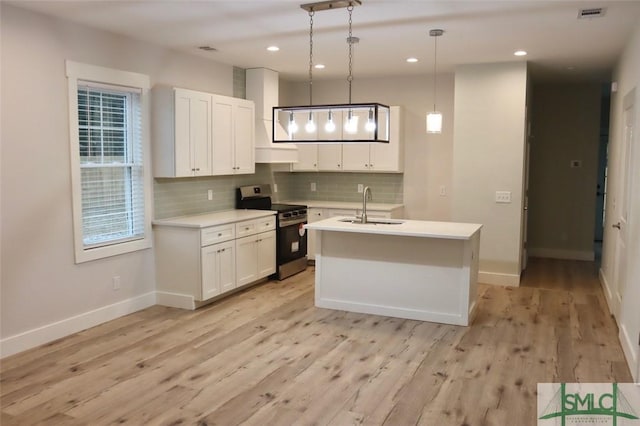 kitchen featuring electric stove, white cabinets, backsplash, and pendant lighting