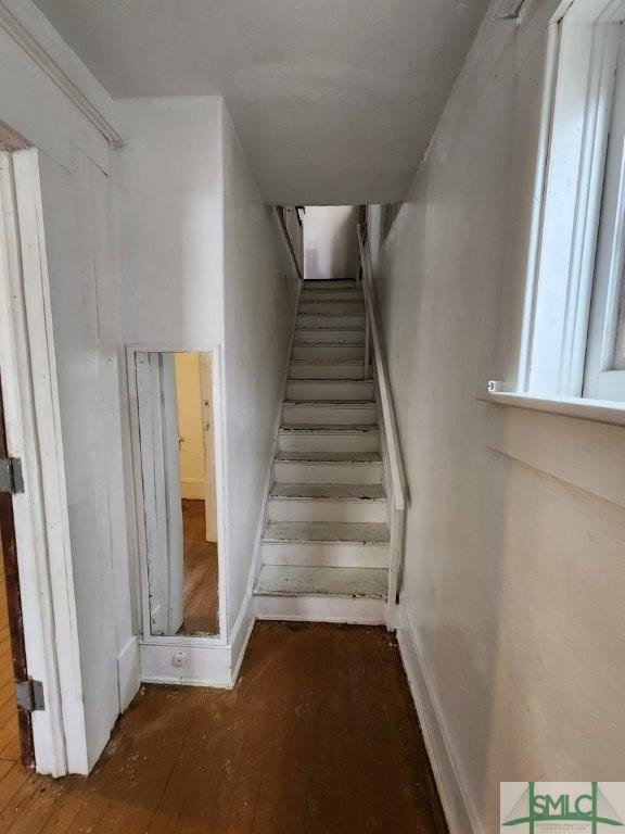 stairs featuring hardwood / wood-style floors