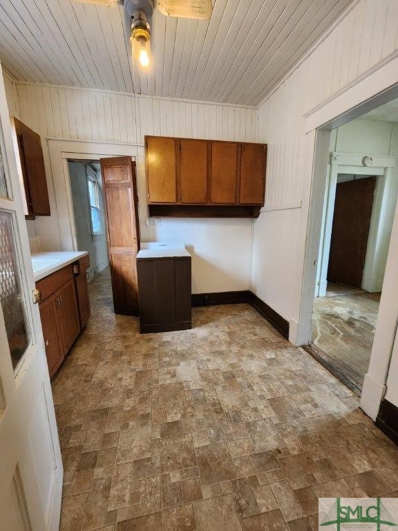 kitchen with wood ceiling and wooden walls