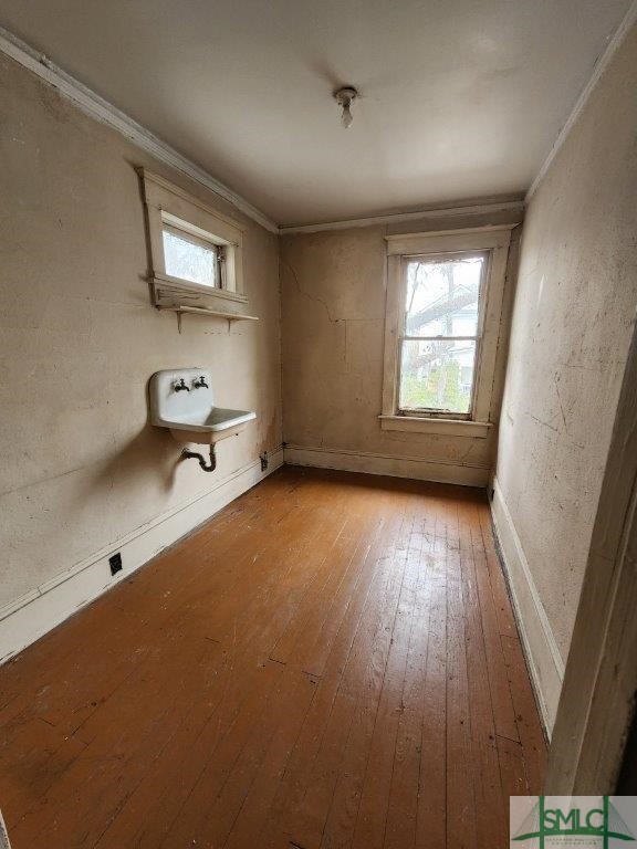 interior space with light hardwood / wood-style flooring and ornamental molding