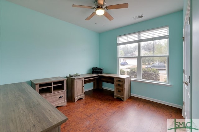 home office with ceiling fan and dark hardwood / wood-style flooring