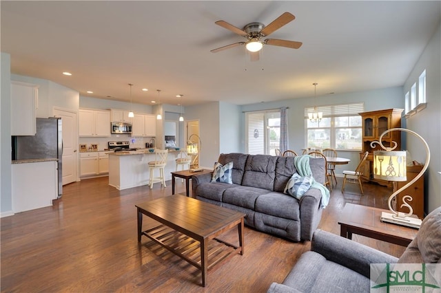 living room with dark wood-type flooring and ceiling fan