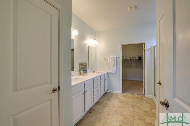 bathroom with vanity and walk in shower