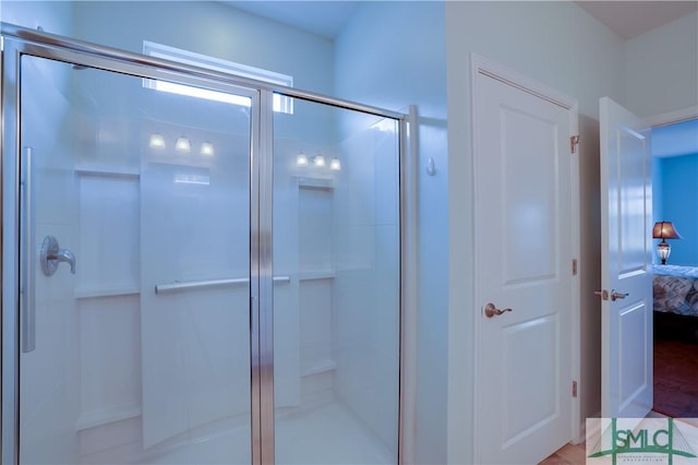 bathroom with a shower with door