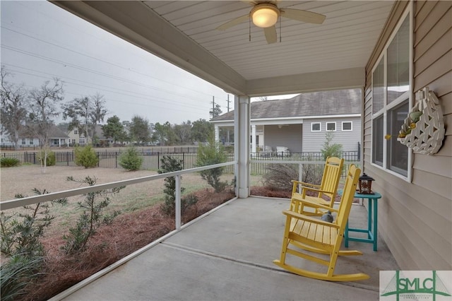 sunroom / solarium featuring ceiling fan